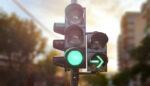Diabetes tech 2022 Green traffic light with green arrow light up in city while suns