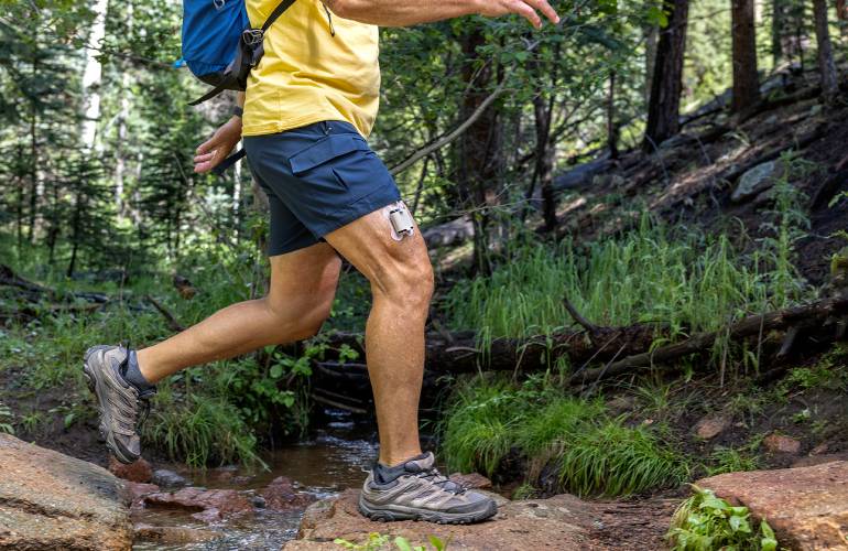 Tandem Diabetes Mobi insulin patch pump worn on hiker's leg